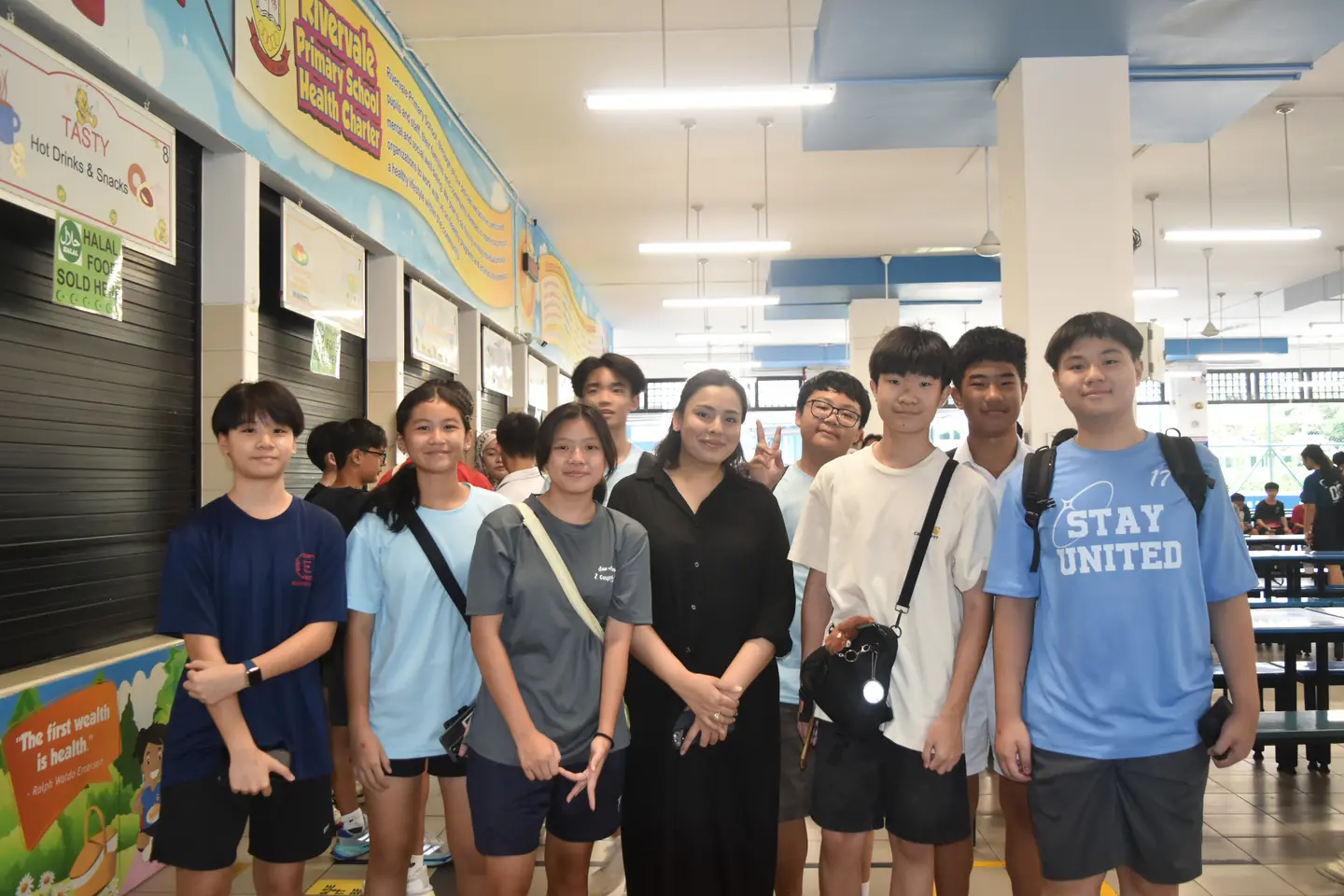 Graduates gathered with a teacher during a previous Teachers’ Day visit