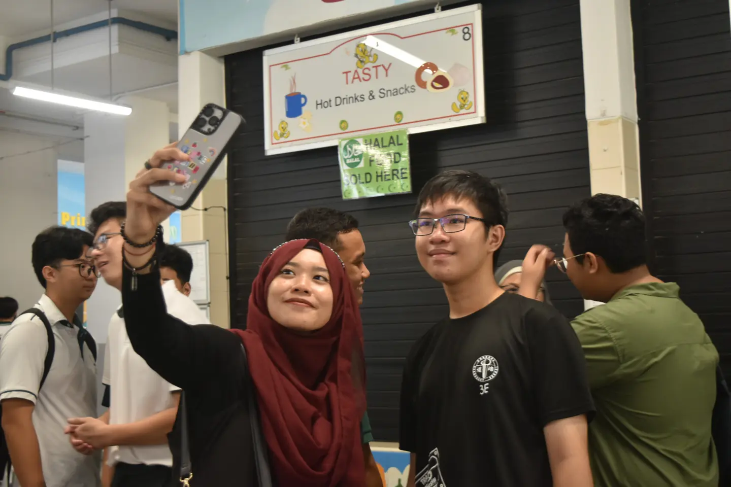 A teacher and graduate taking a photo together